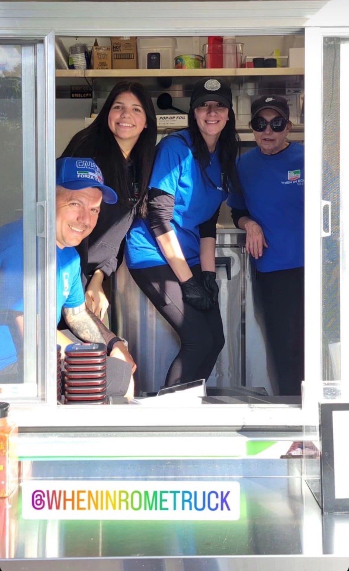 The When In Rome crew smiling together from the truck's service window