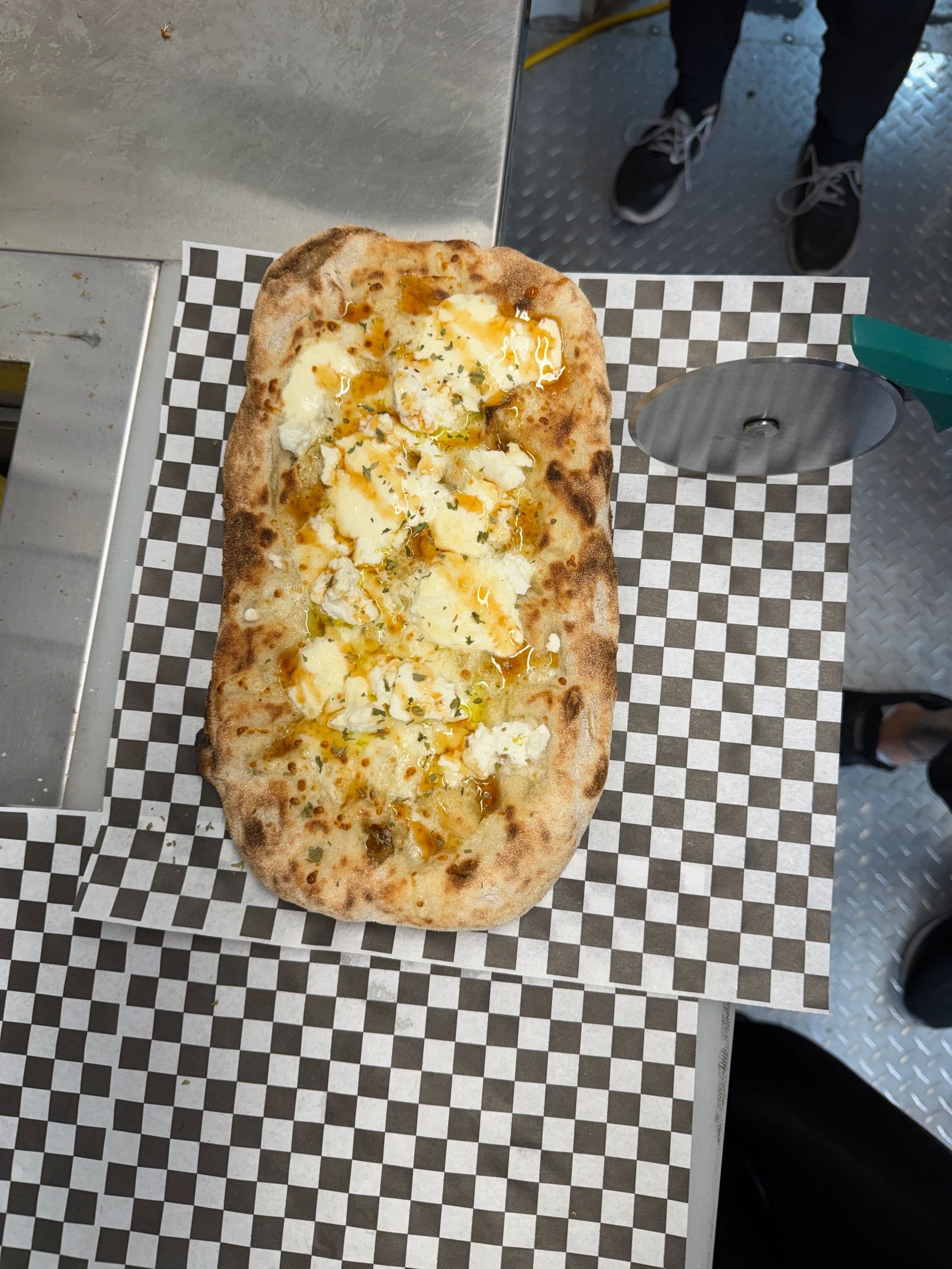 A hand-stretched Bianca Romana pinsa pizza fresh off the When In Rome truck