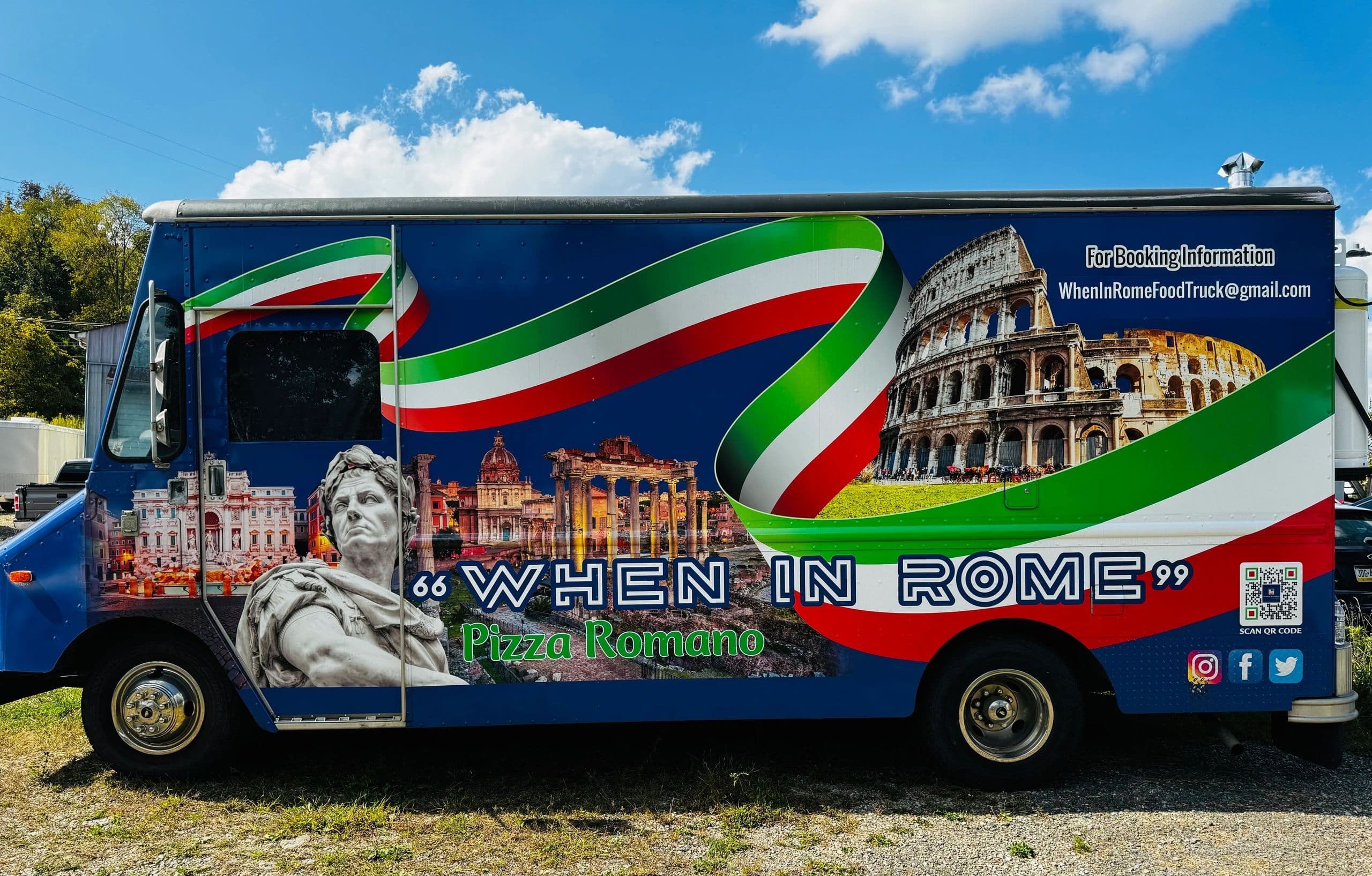 The When In Rome food truck, wrapped in Italian flag colors with a Colosseum mural and Julius Caesar bust, parked outside on a sunny day