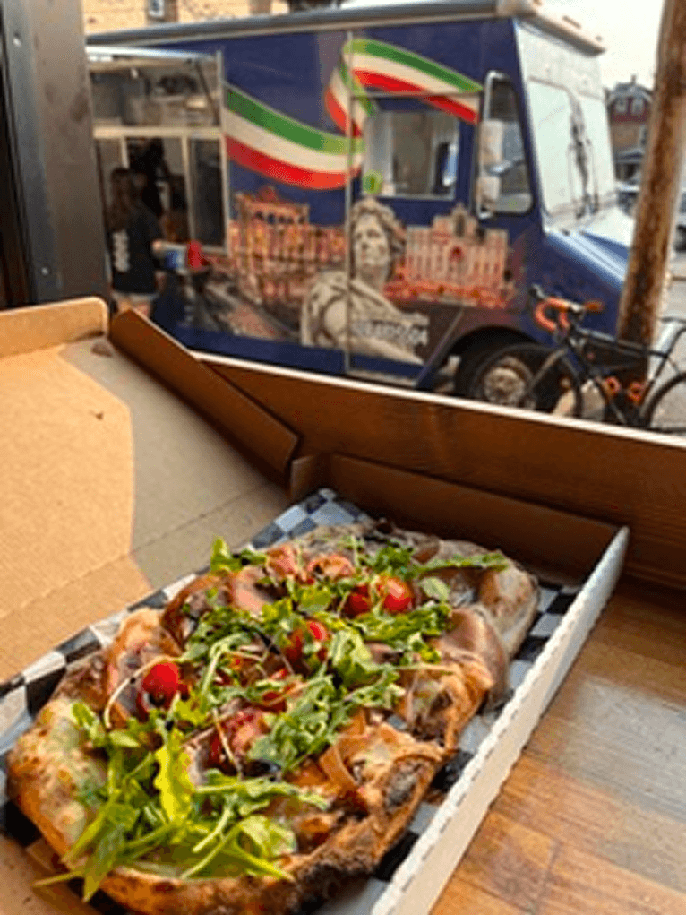 A hand-stretched Bianca Romana pinsa pizza fresh off the When In Rome truck, finished with cheese and a drizzle